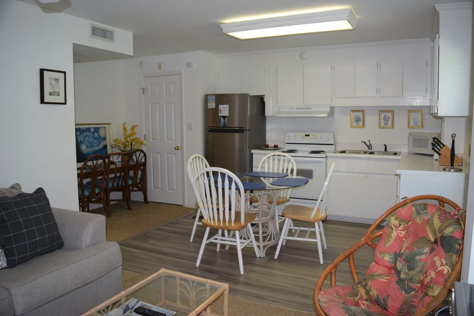 Your bright, open-concept space seamlessly blends kitchen and living areas, perfect for cooking together and relaxing after beach days.