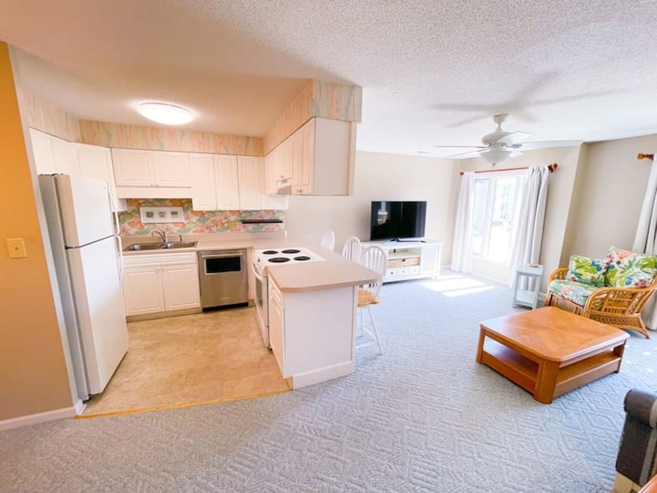 Living Room and kitchen- Comfortable seating and coastal style create a welcoming space to gather, relax, and enjoy time together.