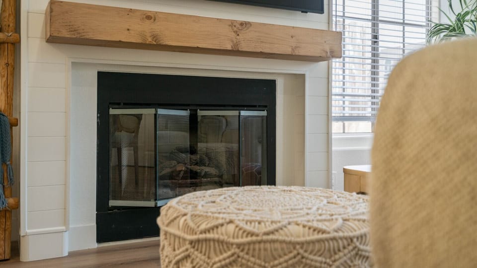 Cozy living room detail featuring a modern fireplace and comfortable furnishings for relaxing evenings at home.
