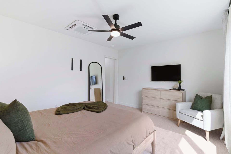 Primary Bedroom with clothing storage, hanging racks, and full length mirrors