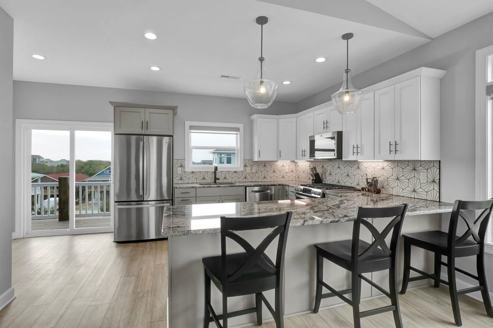 Spacious gourmet kitchen with modern appliances and plenty of counter space for culinary creations and dining.