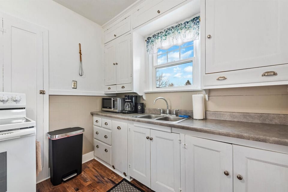 Kitchen with electric stove, microwave, and complimentary locally roasted Sorbenots Coffee!