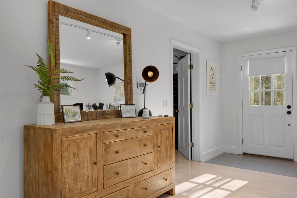 Our bright King guest room offers independent access directly from the front driveway side of the home. This private entrance is perfect for slipping out for a morning walk or loading the car for an Acadia hike without waking the group.