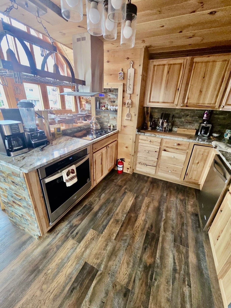 Hickory kitchen with large built-in stainless steel appliances.