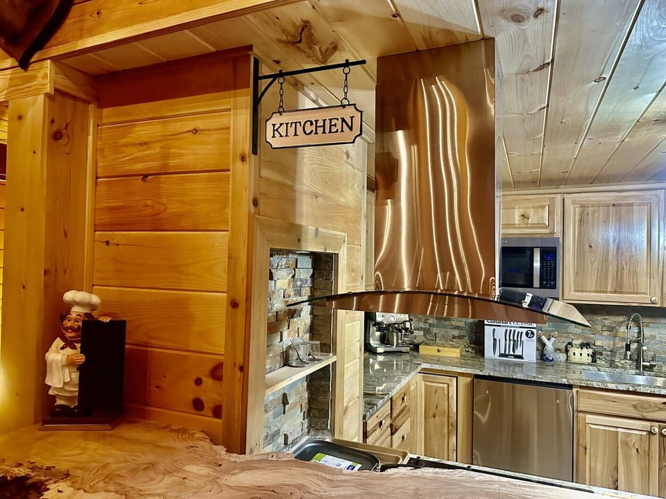 Hickory kitchen with large built-in stainless steel appliances.