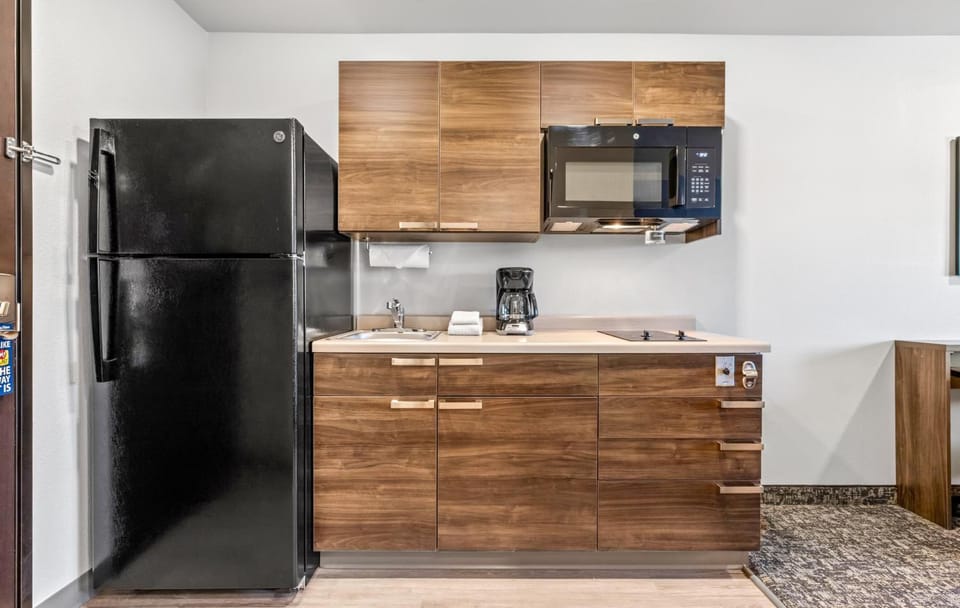 Cook simple meals with full-size fridge, microwave, and cooktop.