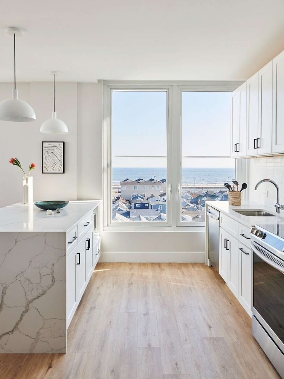 White kitchen with island and ocean view