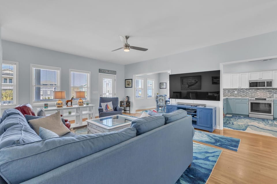 Your bright open-concept living space flows seamlessly from cozy sectional seating to fully equipped kitchen, perfect for gathering and making memories together.