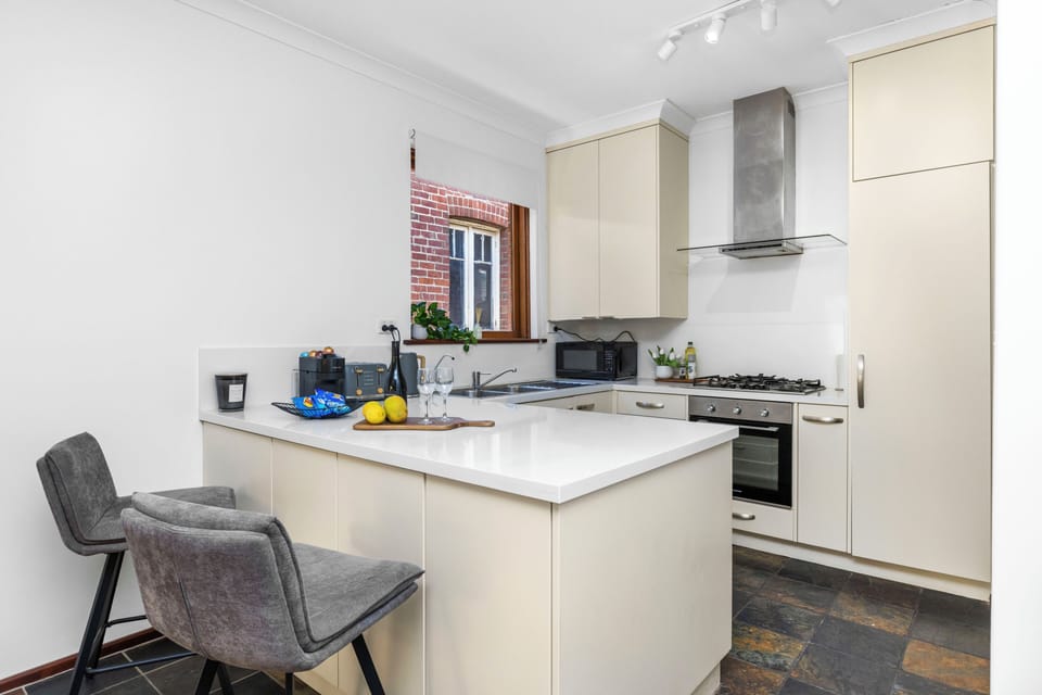 A modern, fully equipped kitchen with everything you need to whip up a gourmet meal or enjoy a quick morning coffee at the breakfast bar.