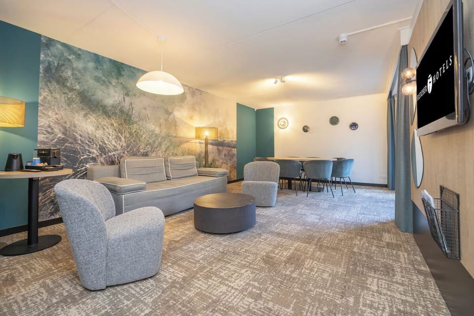 Gather comfortably in the spacious lounge with soft seating and light.