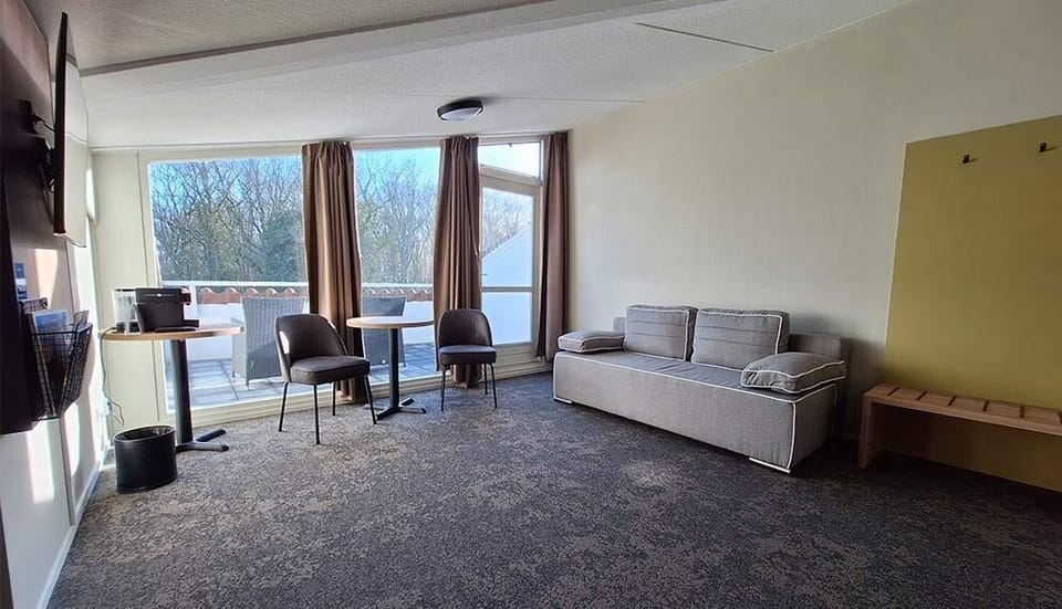 Gather for drinks and conversation beside sunlit windows.
