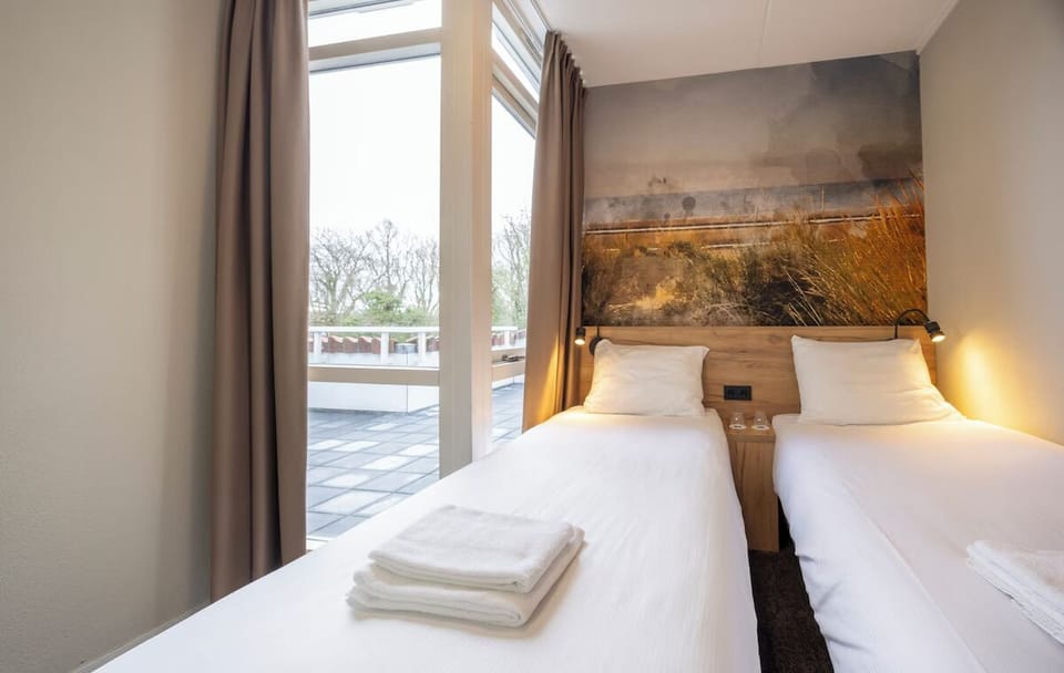Settle into cozy twin beds with fresh towels ready.