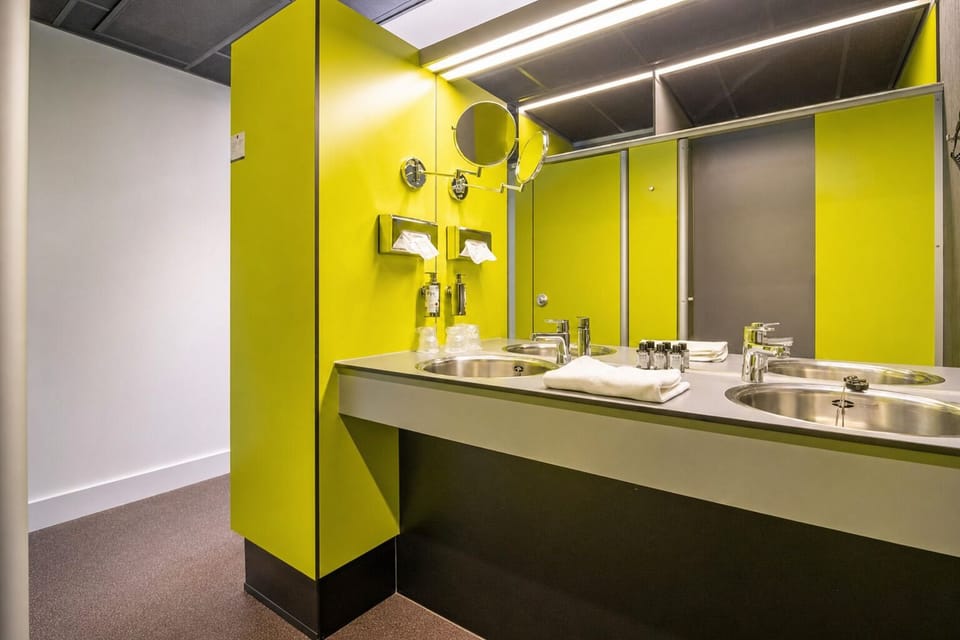 Freshen up at a bright vanity with fluffy towels ready.