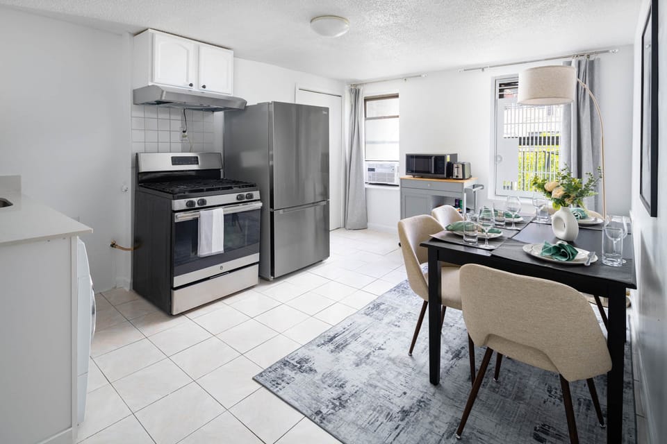 Bright kitchen with stainless appliances & stylish dining for four