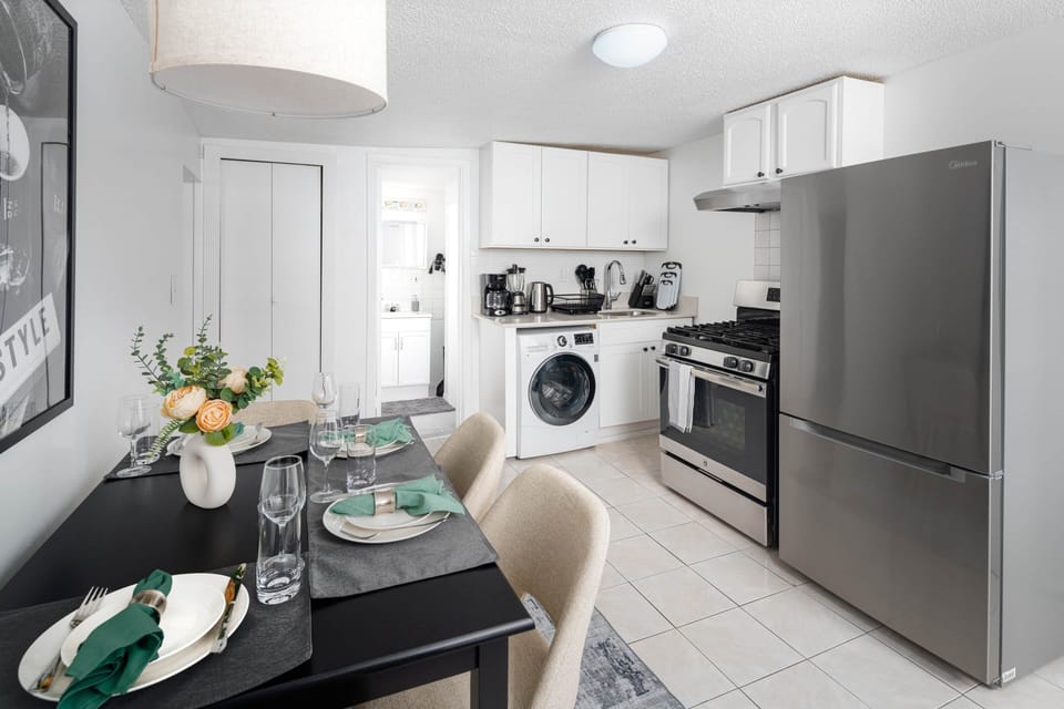 Spacious kitchen with stainless appliances, dining area & in-unit washer