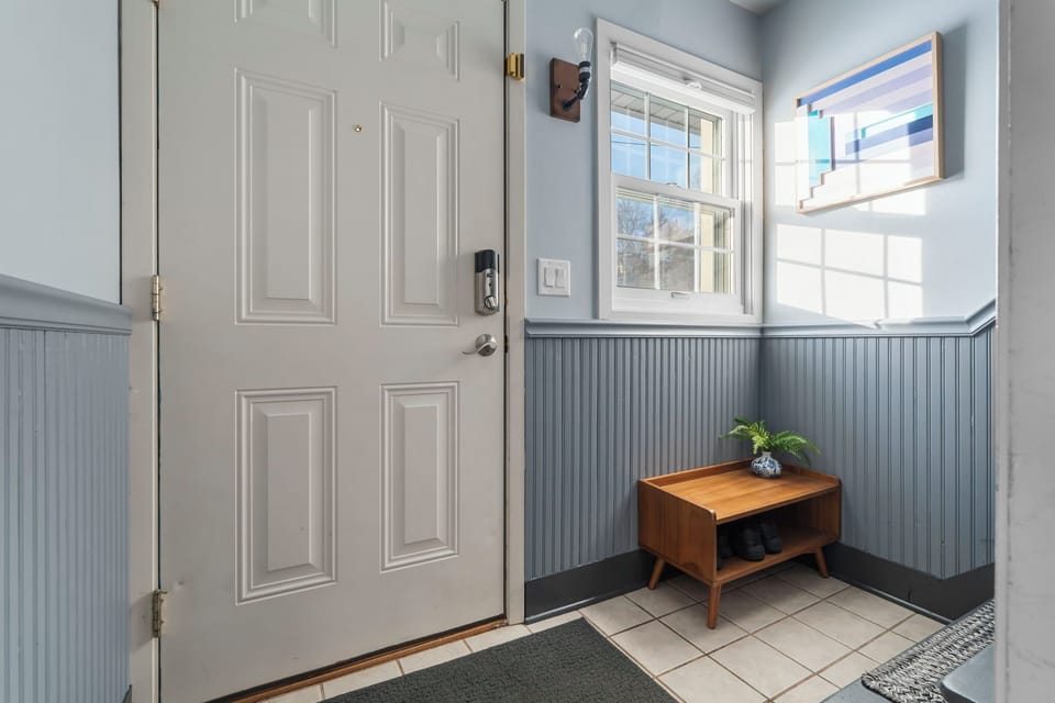 08 — Private Entry Foyer with Beadboard Wainscoting Smart Lock and Shoe Bench