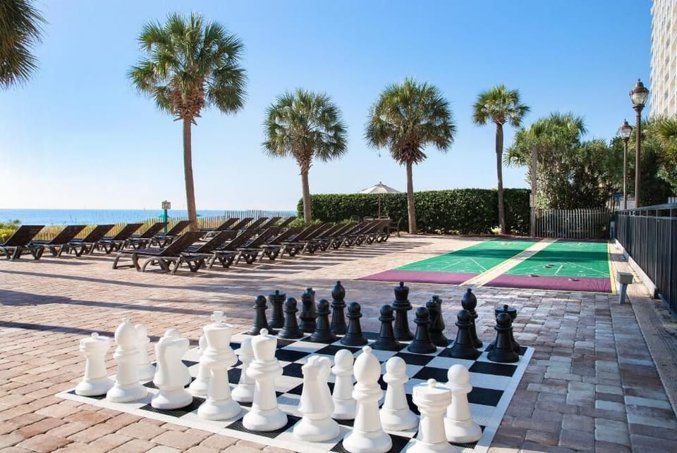 Unwind poolside with ocean breezes, loungers, and giant chess.