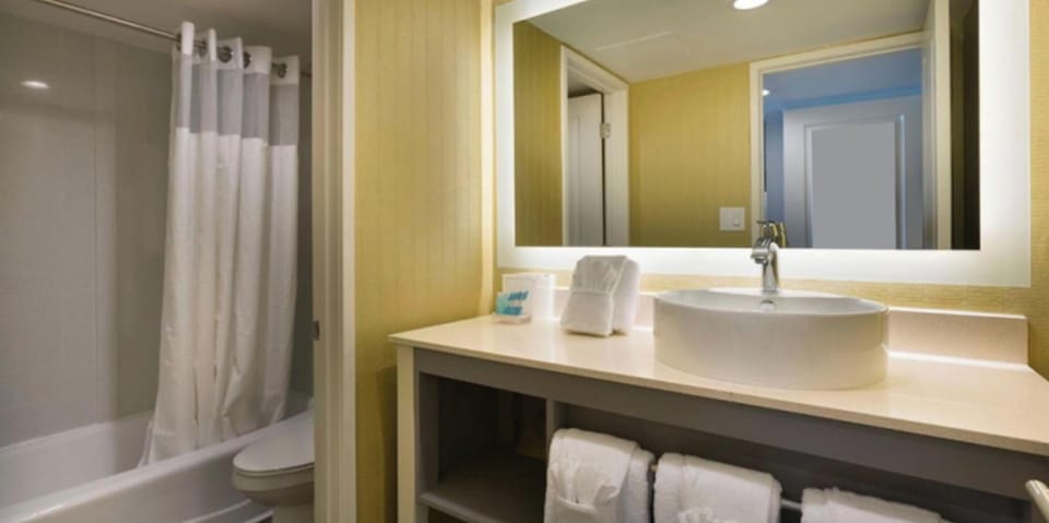 Step into a spotless bath with plush towels ready.