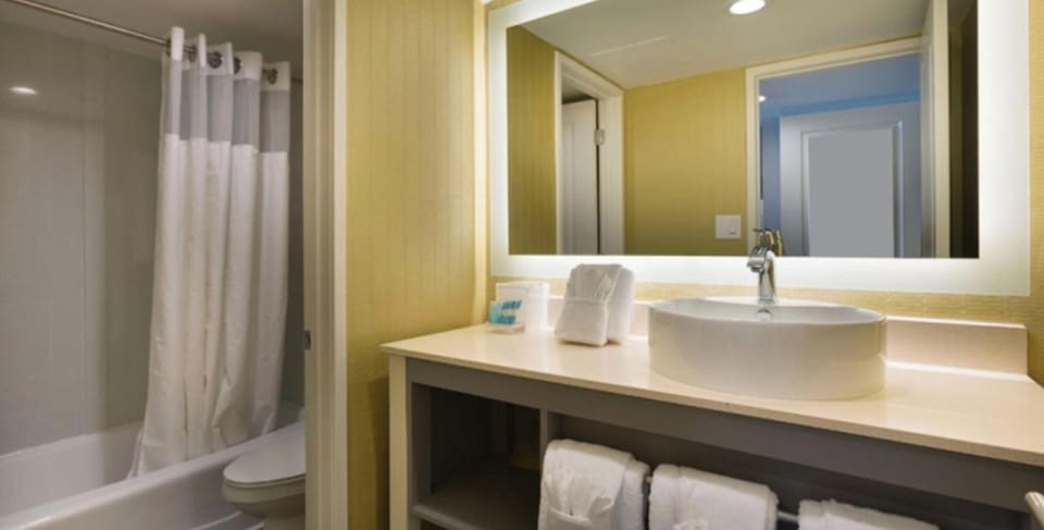 Step into a spotless bath with plush towels ready.