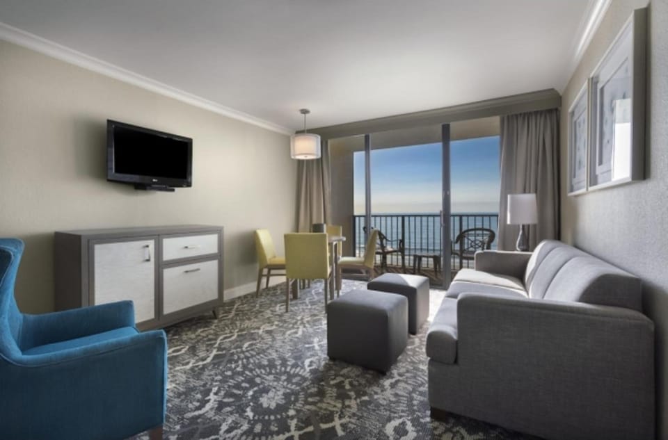 Sip morning coffee while ocean views glow through glass doors.