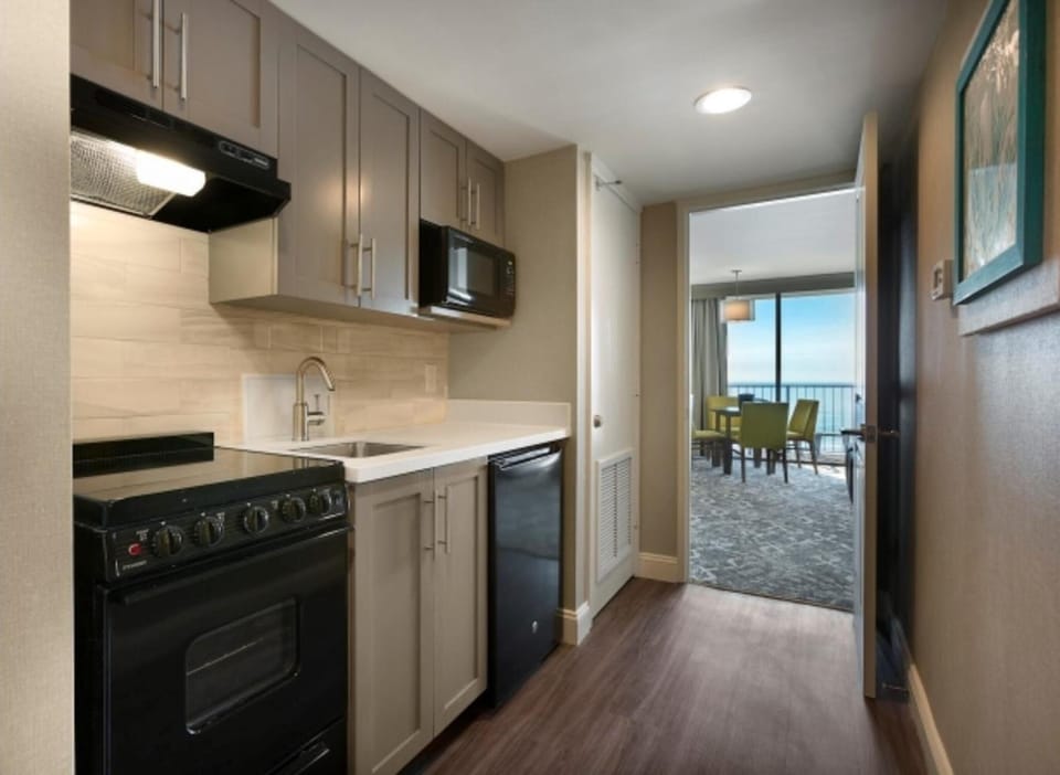 Cook easy meals with a sleek kitchenette and modern appliances.