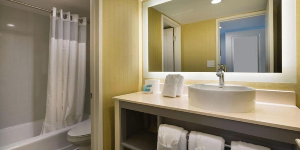 Step into a spotless bath with plush towels ready.