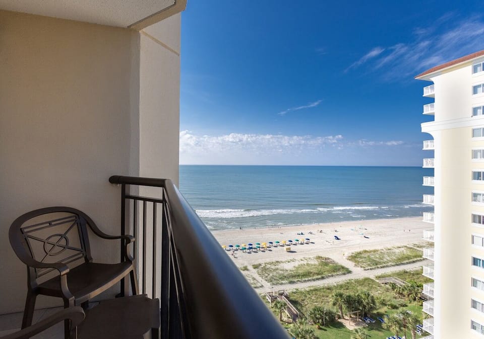 Sip morning coffee on the balcony with sweeping sea views.