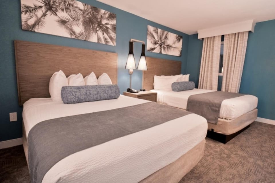 Stretch out on crisp linens in a calm coastal bedroom.