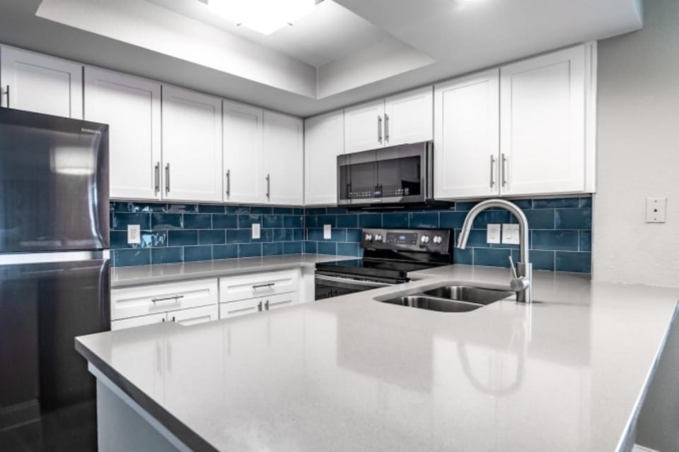 Cook and gather around sleek counters in a bright kitchen.