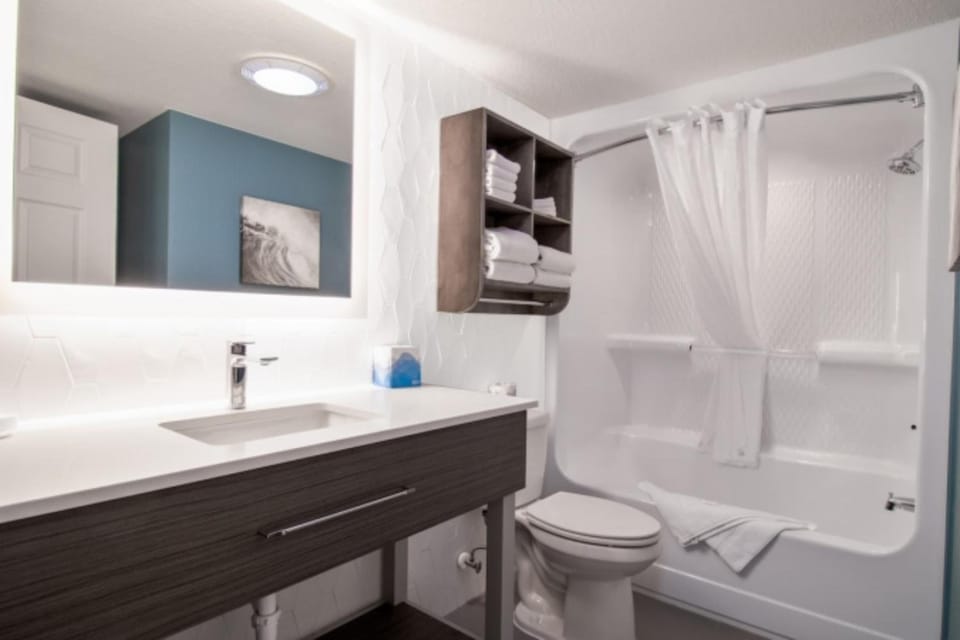 Refresh effortlessly in a spotless bath with plush towel storage.