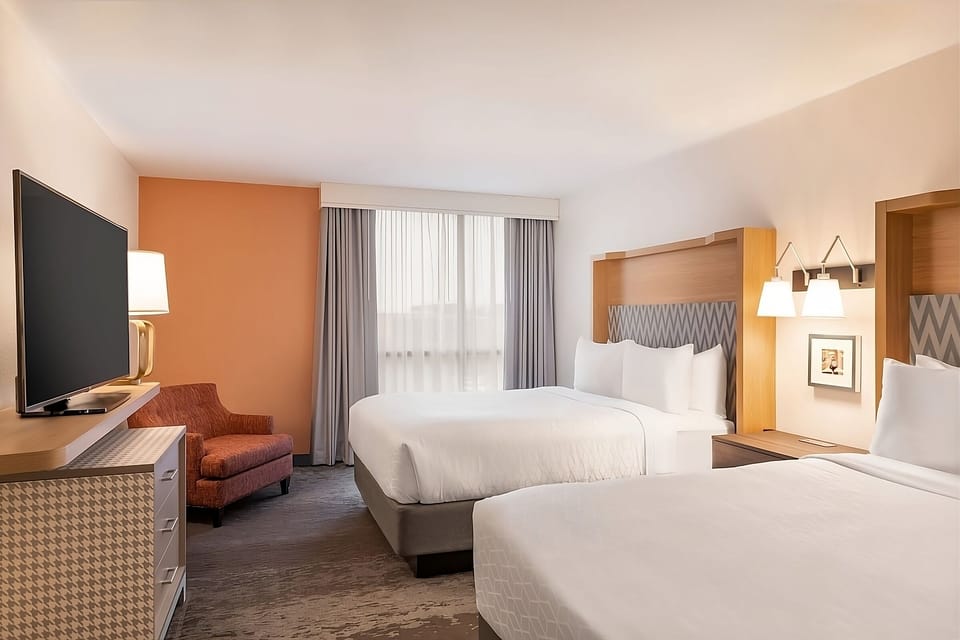 Relax in a warm, modern room with cloud-soft bedding.