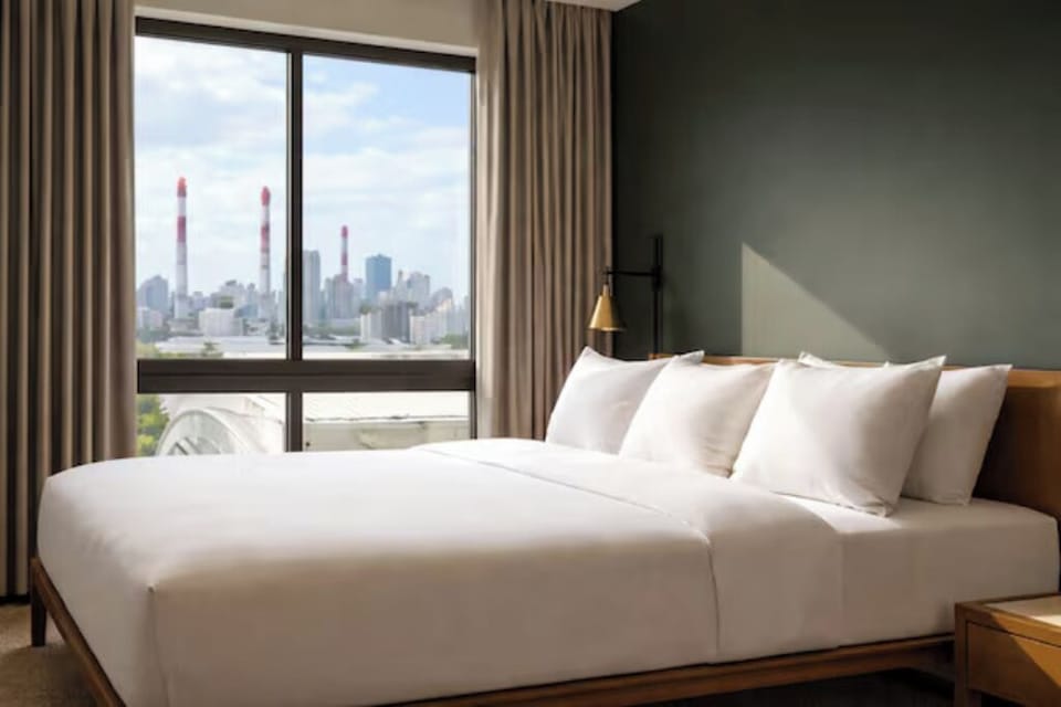 Wake up refreshed in crisp linens with skyline views.