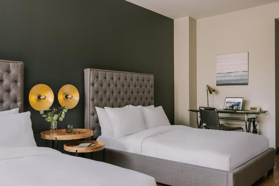 Relax in a spacious room with comfortable beds and workspace.