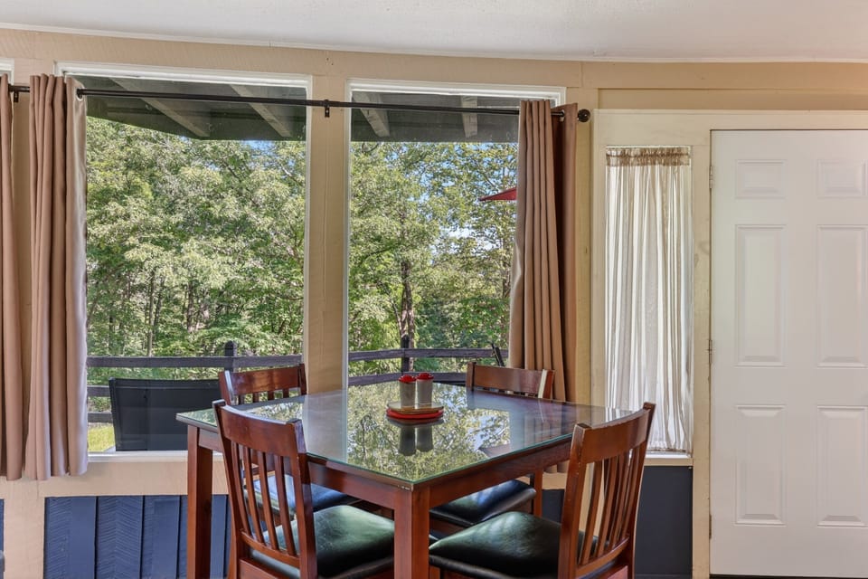 Enjoy meals and morning coffee at the dining table with peaceful wooded views.