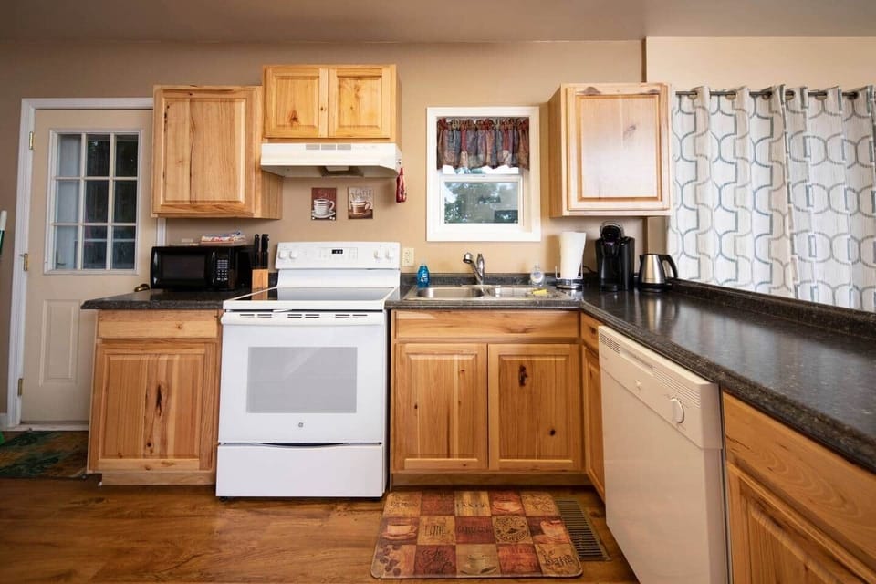 A fully equipped kitchen, complete with everything you need to prepare and cook your meals, including ample counter space, and a dishwasher to help with cleanup afterward. 