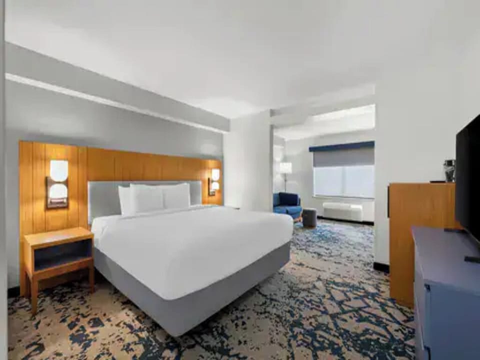 Stretch out on a plush king bed in airy comfort.