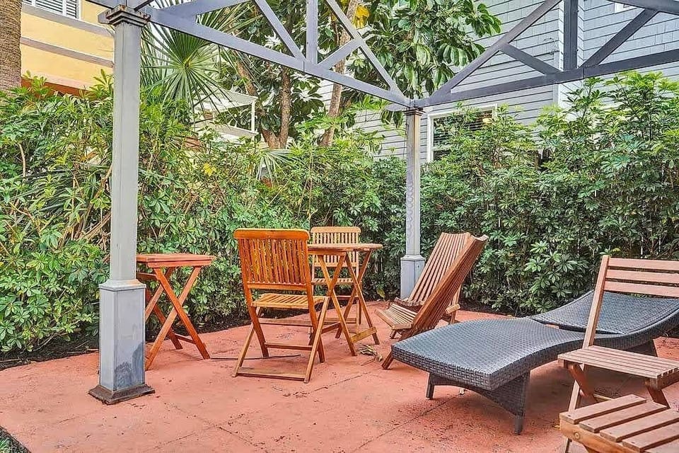 Shared patio with dining table and sun lounger