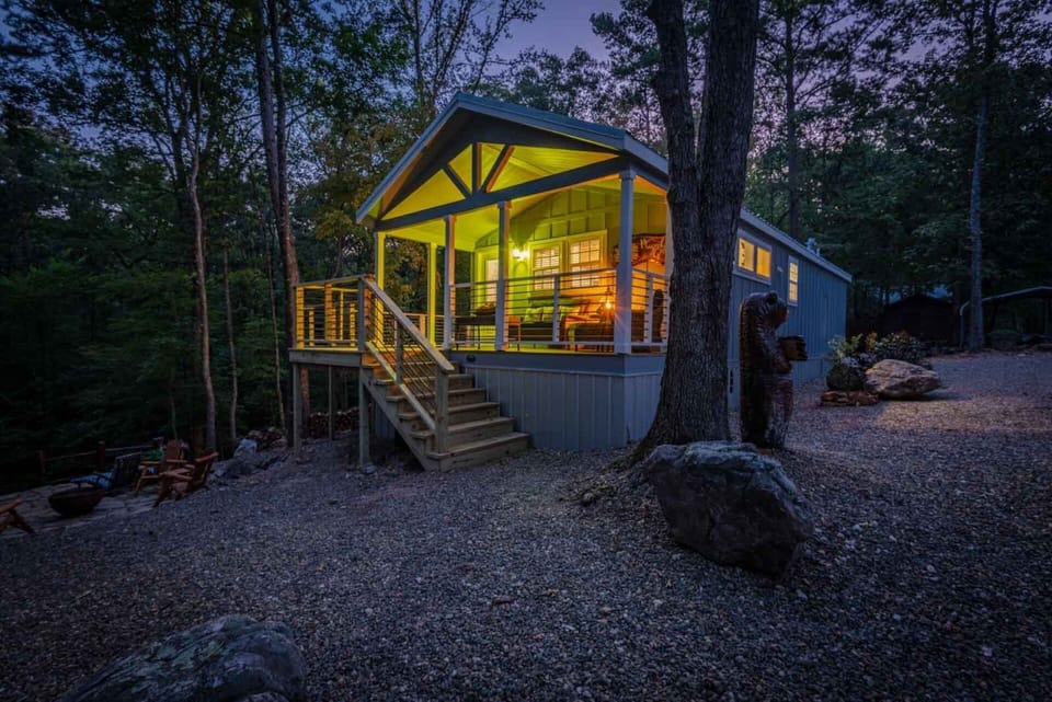 Glowing forest cabin at dusk
