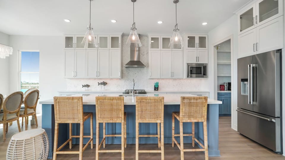 Spacious kitchen island with bar seating for multiple guests, ideal for entertaining in this luxury coastal Galveston vacation home.