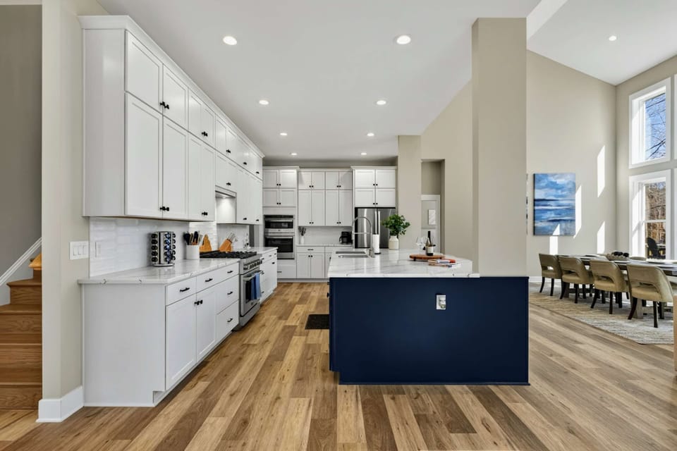 Full Kitchen - White cabinetry, quartz counters, and a navy island give this kitchen both style and substance.