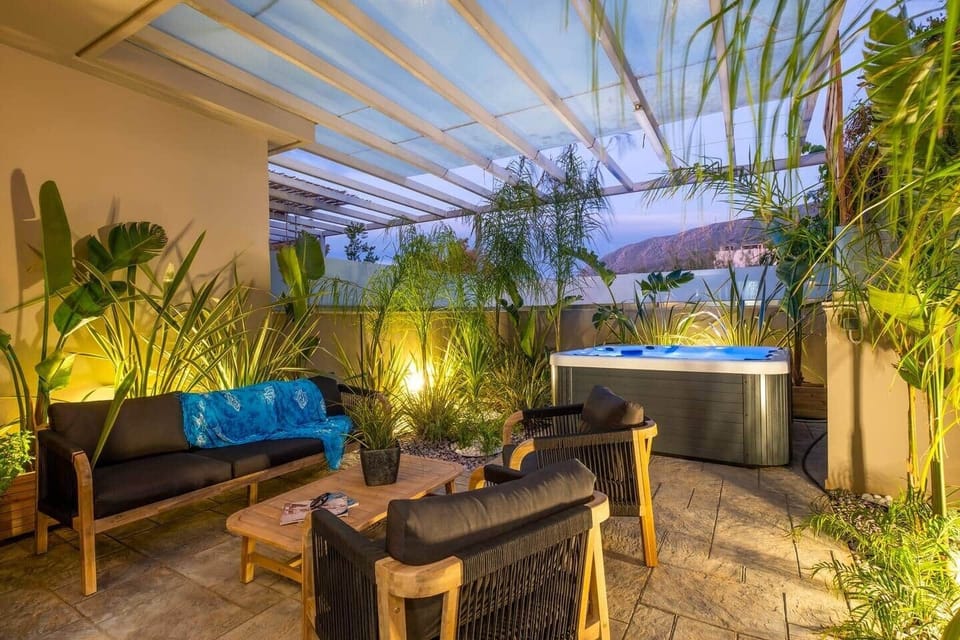A beautiful  fully fenced and private inner courtyard with outdoor furniture, a 4 seated jacuzzi and local flora that create a unique feeling of sheer privacy and relaxation