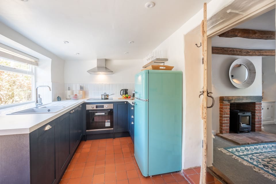 Ground floor: Kitchen with electric cooker and hob, microwave, dishwasher and fridge/ freezer