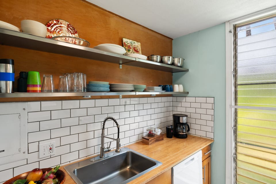 Enjoy cooking in this bright kitchen area, featuring warm wood counters and natural light from the window.