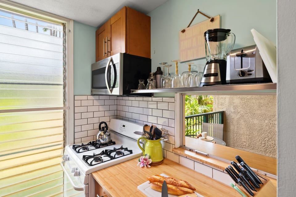 Fully equipped kitchen with gas stove, modern appliances, and ample counter space for easy meal preparation