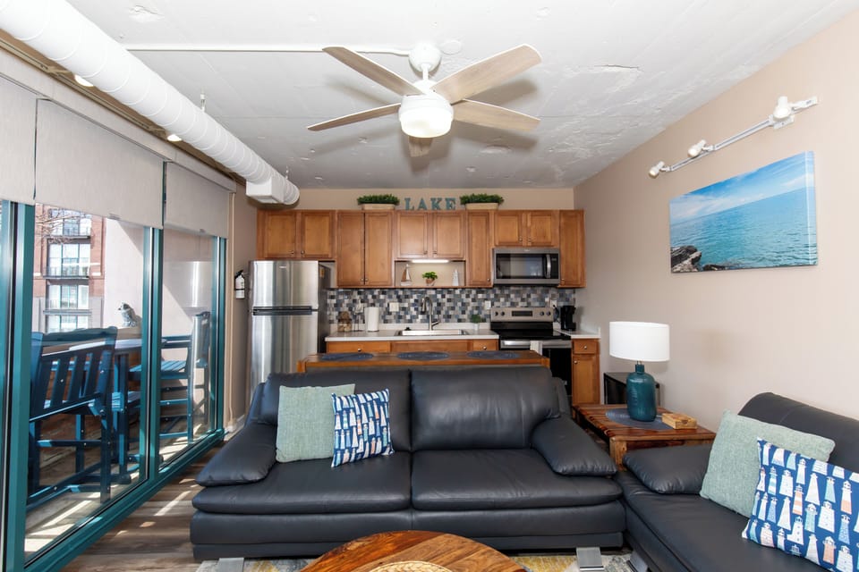 Relax in your open-concept living space with lake-themed touches, modern kitchen, and cozy seating perfect for unwinding after exploring.