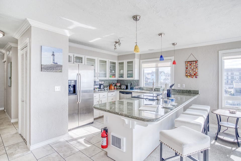 Your gourmet kitchen features granite countertops, stainless appliances, and a breakfast bar where you'll start each morning with coffee and stunning views.