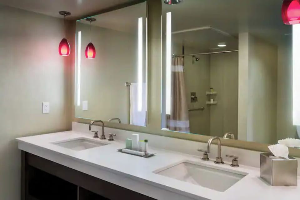 Get ready easily with double sinks and bright mirror lighting.
