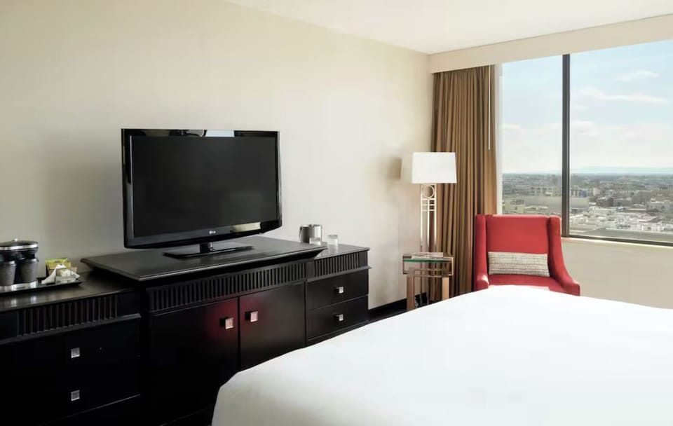 Wake up to skyline views from crisp, sunlit bedding.
