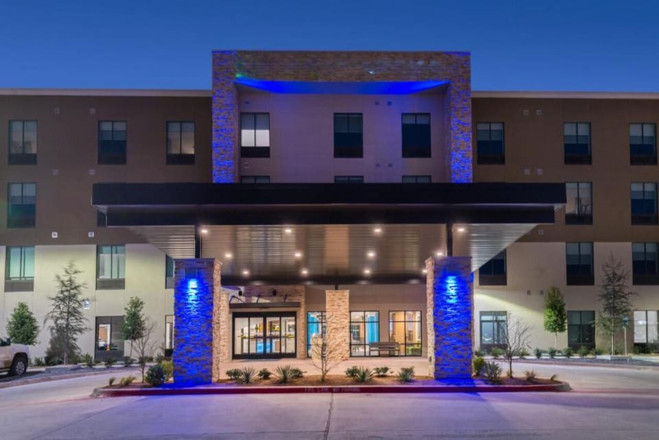 Step into a welcoming glow with dramatic evening curb appeal.