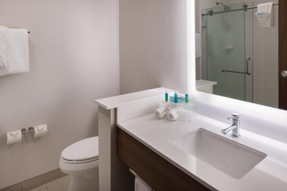 Refresh easily with bright vanity, plush towels, and glass shower.